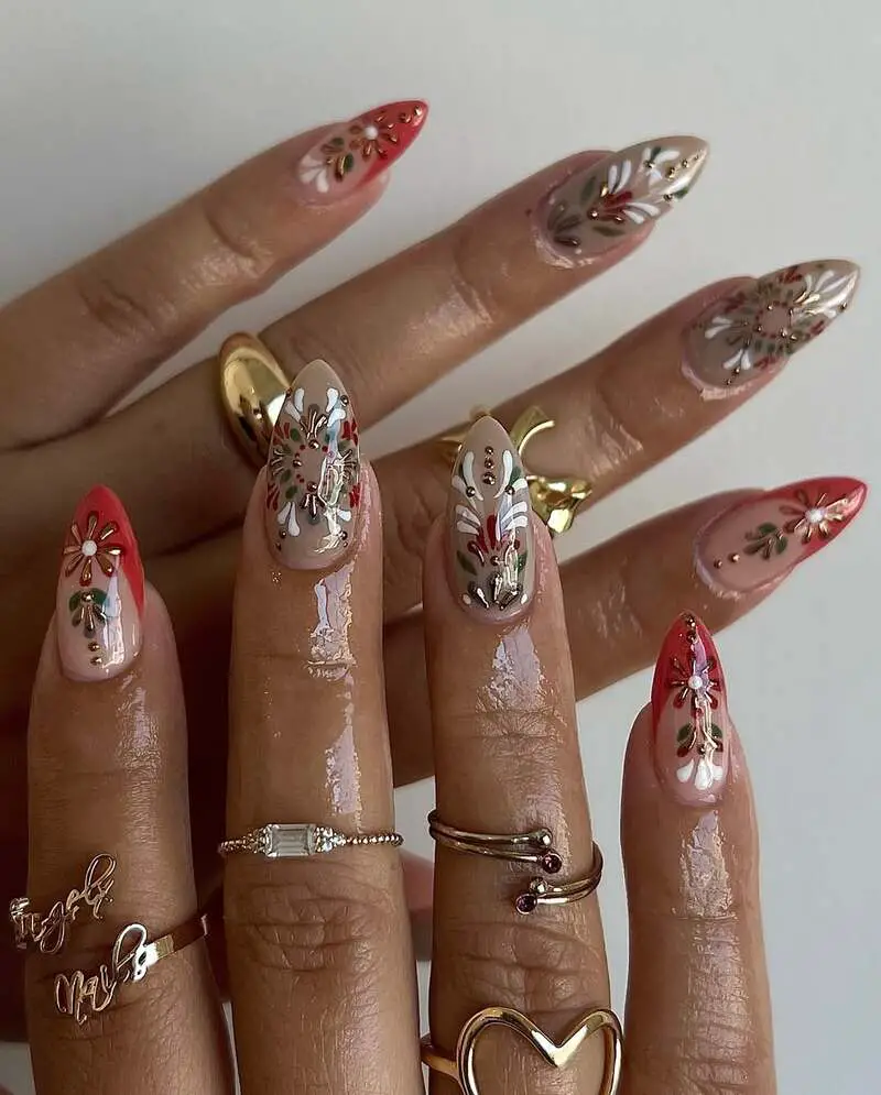 Nude and red nails with detailed floral paintings and gold accents