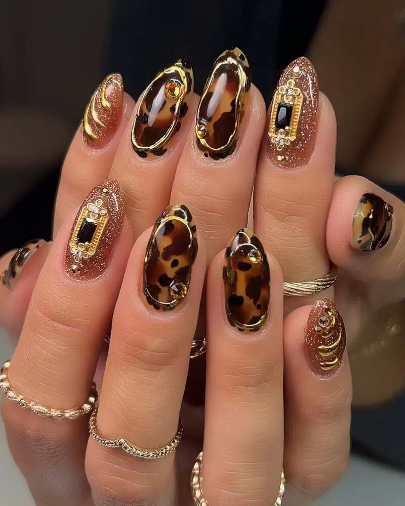 Tortoiseshell and rose gold glitter nails with gold embellishments