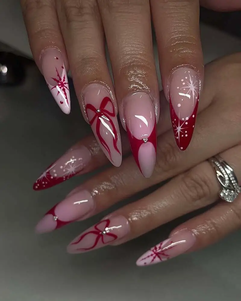 Pink nails with red holiday designs featuring stars, bows and sparkles