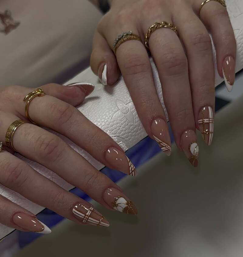 Nude and white plaid nails with gold accents and French tips