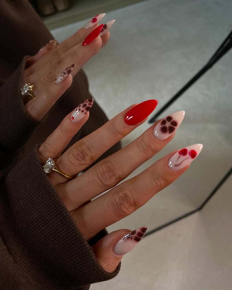 Nude and red Valentine's themed nails with hearts and leopard prints